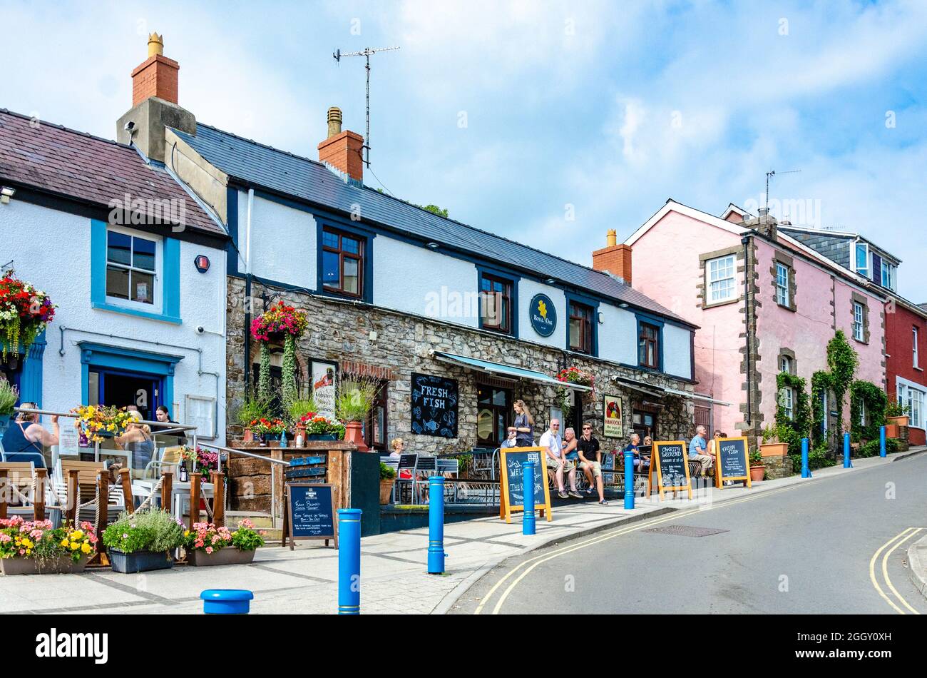 A view of The Royal Oak in on Wogan Terrace in Saundersfoot, Wales, UK on a summer's day with blue sky with broken cloud. Stock Photo