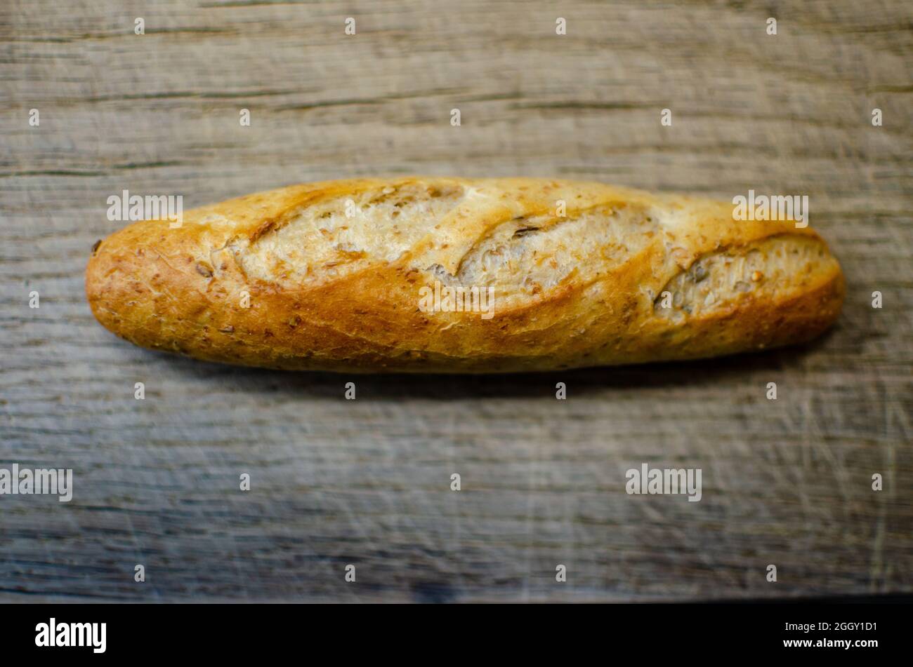 freshly baked bread on an oak cutting board Stock Photo
