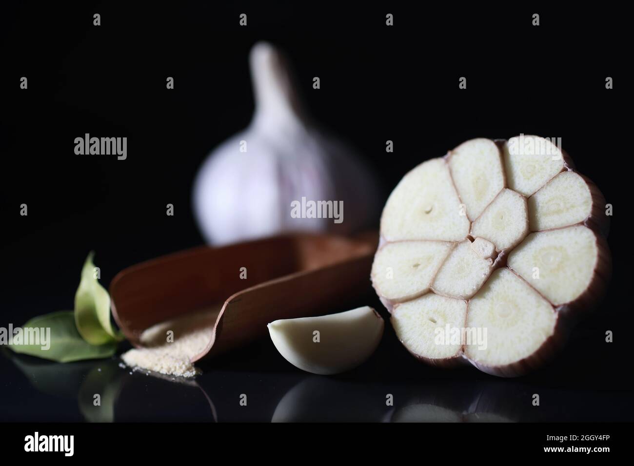 Fresh garlic clove on black background. Garlic is rich in vitamins ...