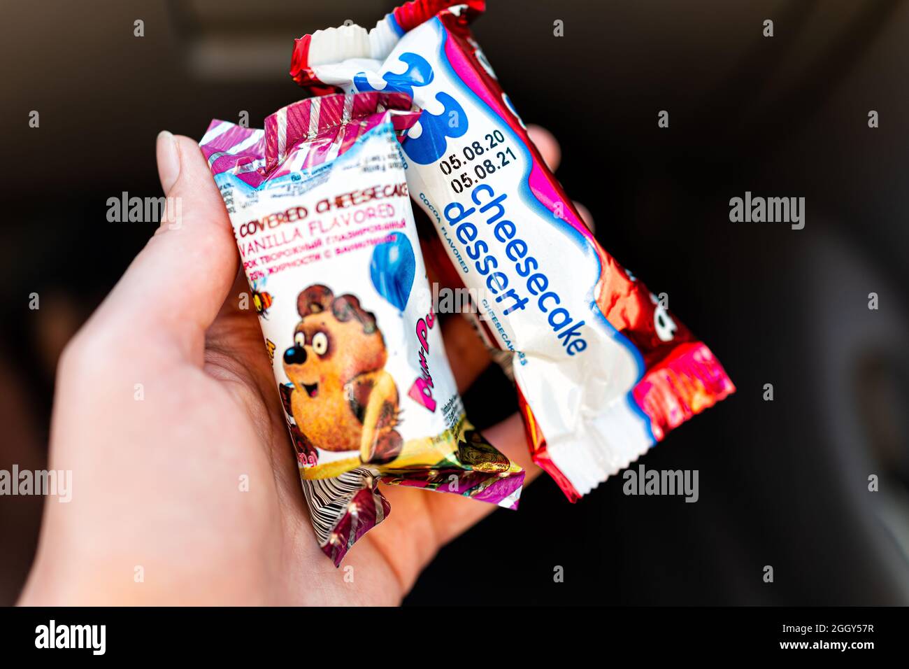 Miami, USA - January 19, 2021: Storebought Russian delicious cheesecake bars coated in chocolate with chocolate and vanilla packaged in hand from Russ Stock Photo