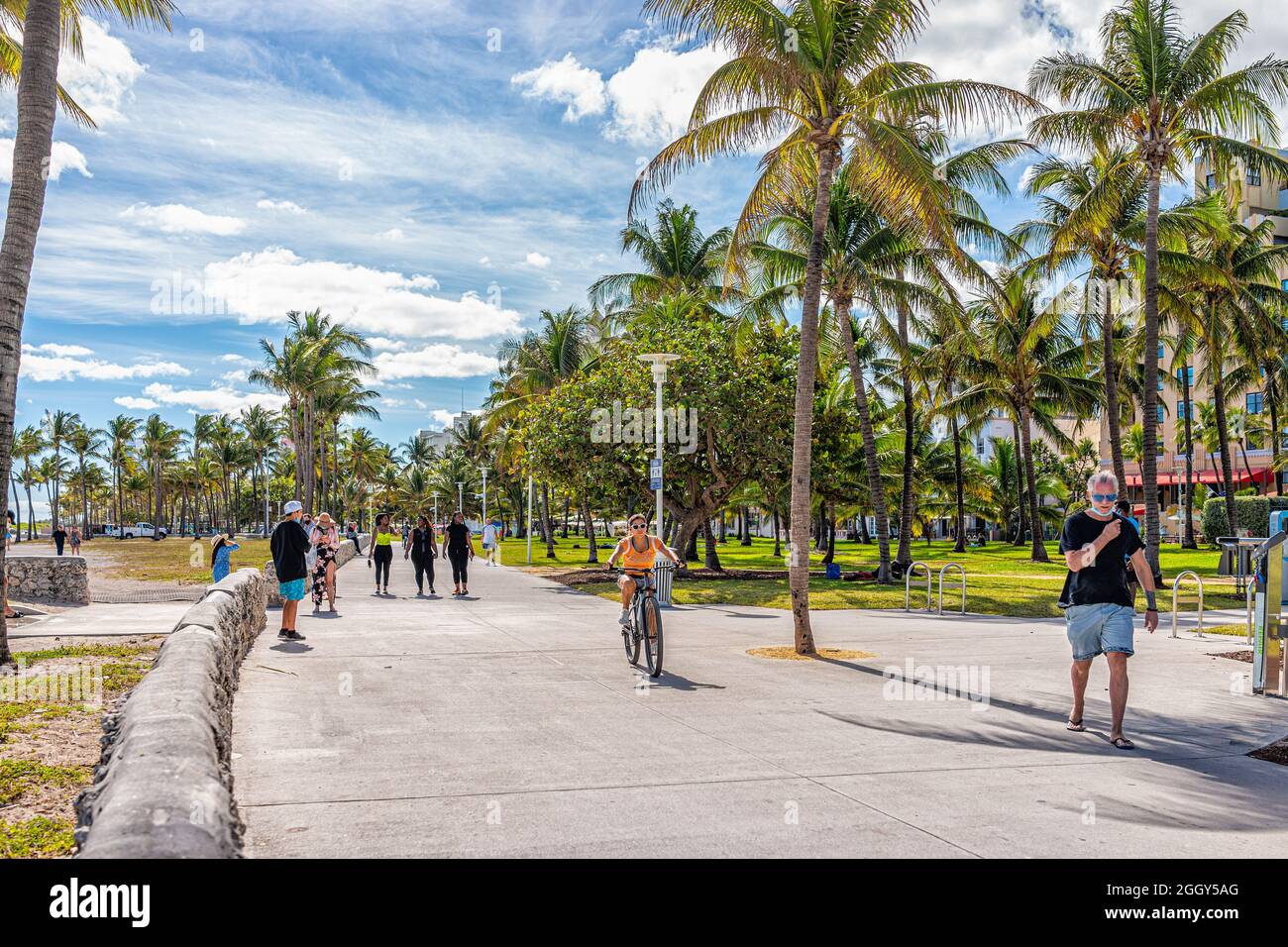 Miami Beach, USA - January 20, 2021: People walking on ocean walk boardwalk at Lummus public park by Ocean drive in art deco district of South Beach, Stock Photo