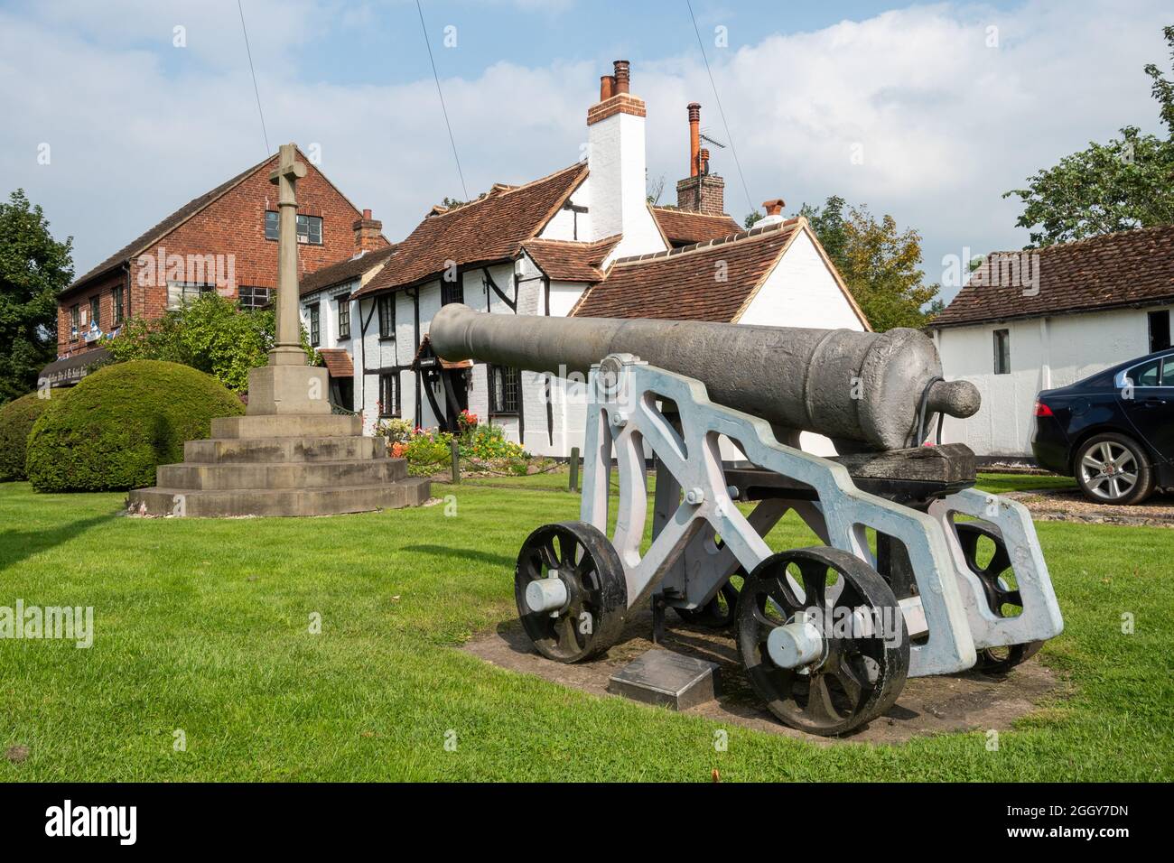 The historic cannon and war memorial in front of cottages in Chobham, a