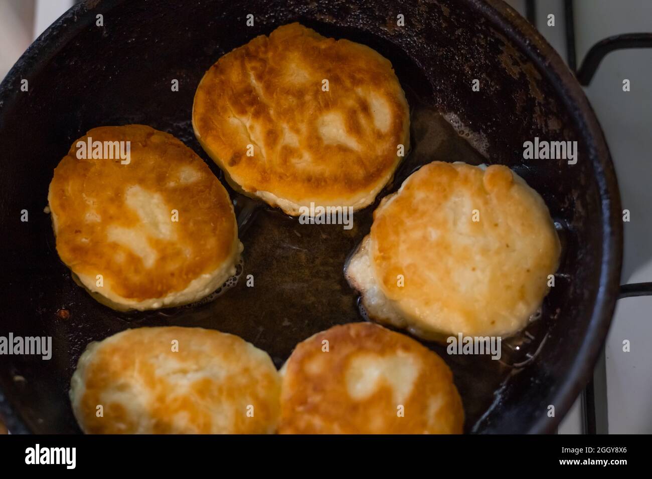 Freshly fried pancakes are prepared for breakfast. Cooking food in the kitchen. Stock Photo