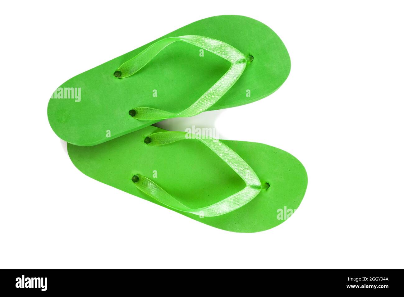 green rubber beach flip flops on a white background, isolate, view from