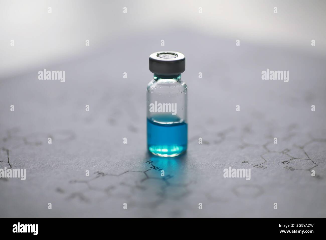 small jars with injection and syringe for injection on blue background ...
