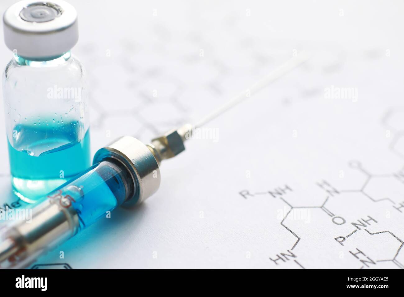 small jars with injection and syringe for injection on blue background ...