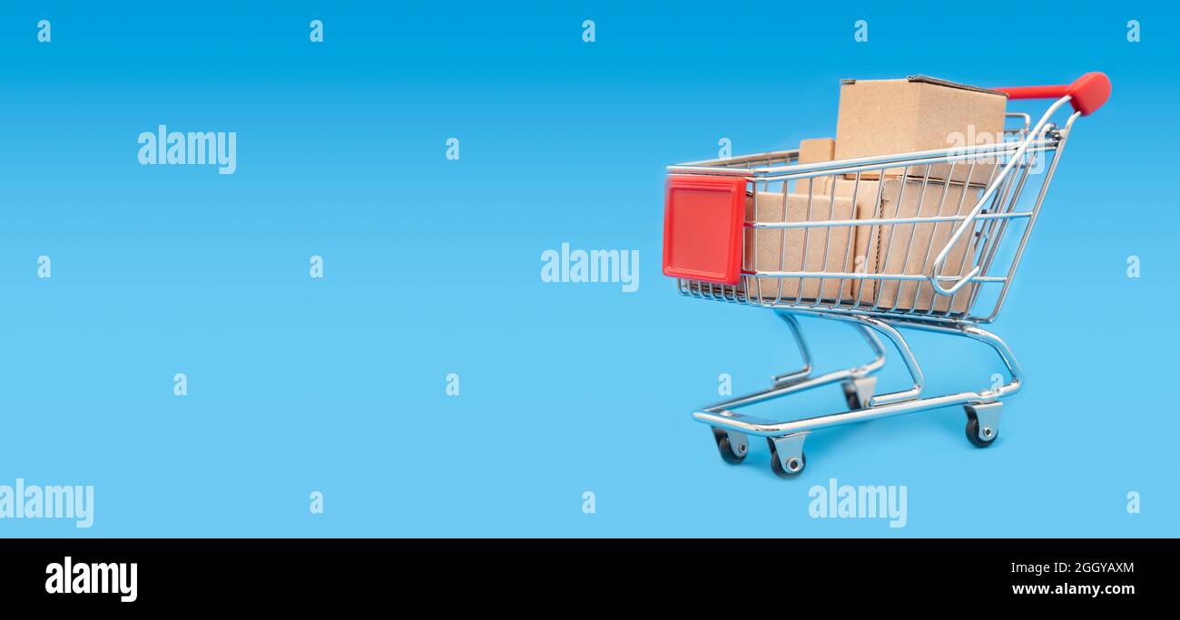 Shopping trolley with cardboard boxes. shopping concept Stock