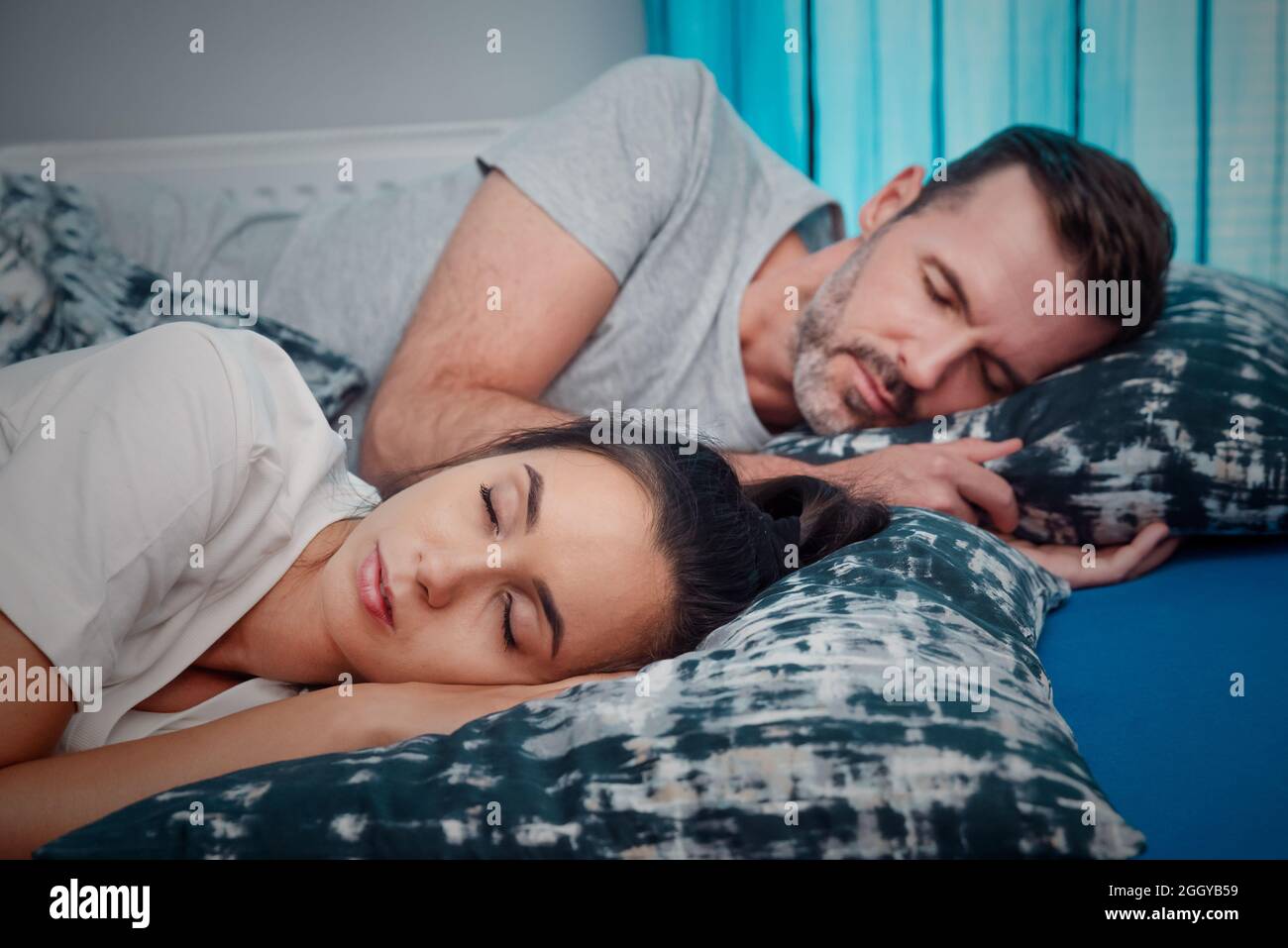 Young couple sleeping in bed. Healthy sleep concept Stock Photo