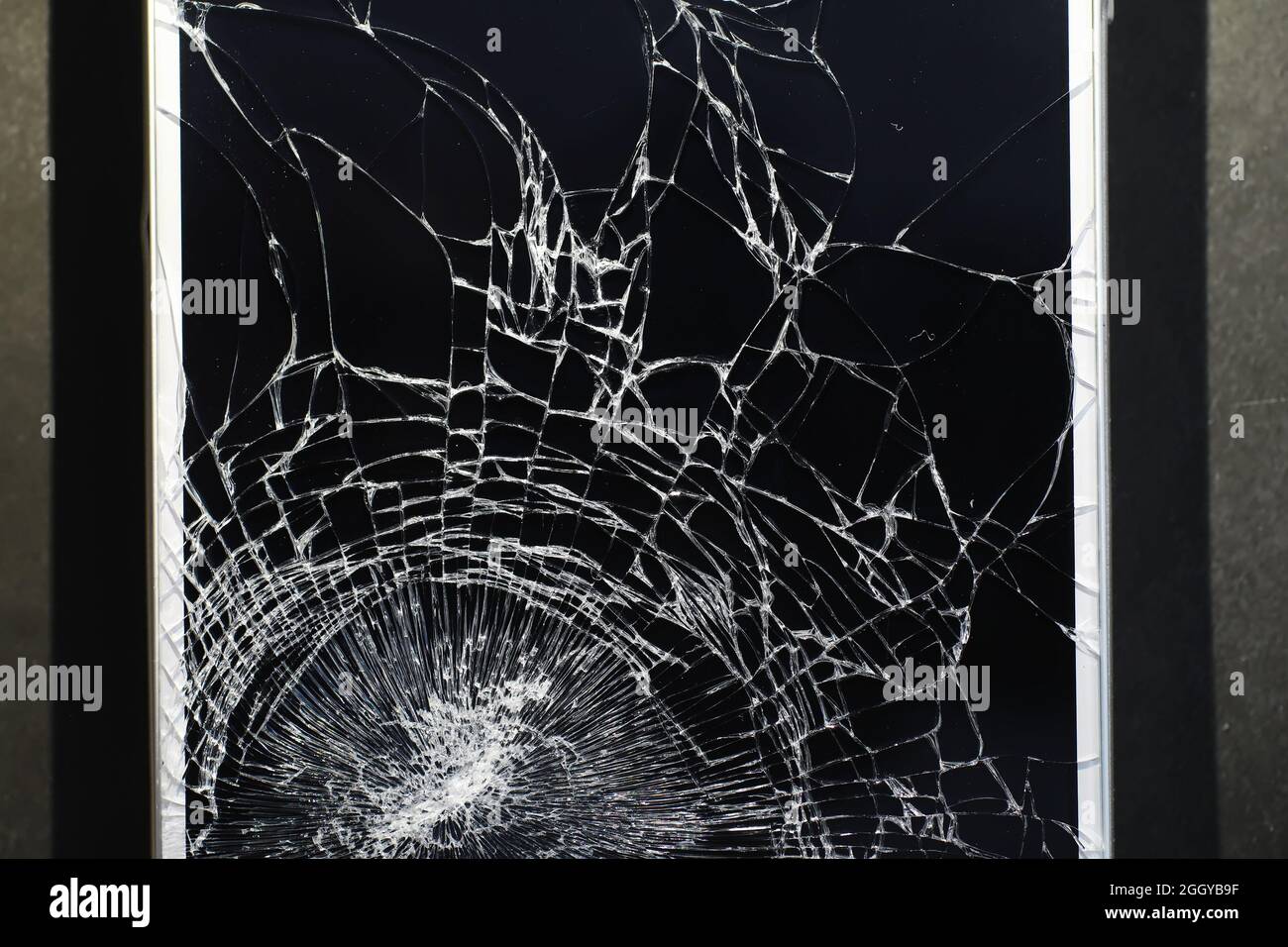 Crack on the glass. Broken screen. Broken phone. Cracked glass background.  White cracks in glass Stock Photo - Alamy