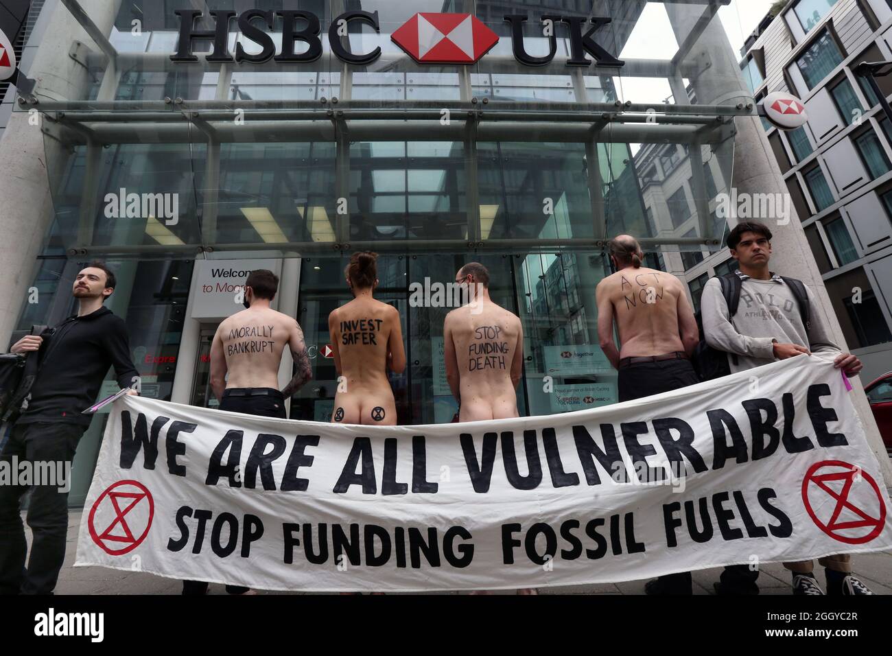 London, UK. 03rd Sep, 2021. Naked rebels protest behind their banner  outside HSBC, Moorgate as XR Activists protest in banks in the City of  London to highlight the fact that we all