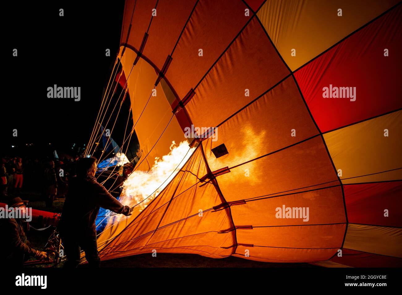 Crew inflating hot air balloon with propane flame, Albuquerque International Balloon Fiesta