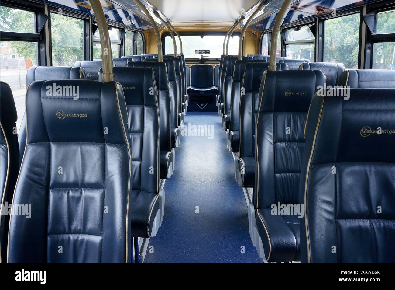 Inside the top deck of an empty Stagecoach gold double decker bus with faux leather seating Stock Photo