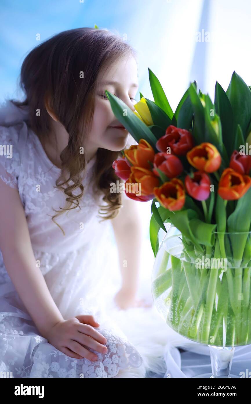 Beautiful girl in white dresses with a magnificent bouquet of first ...