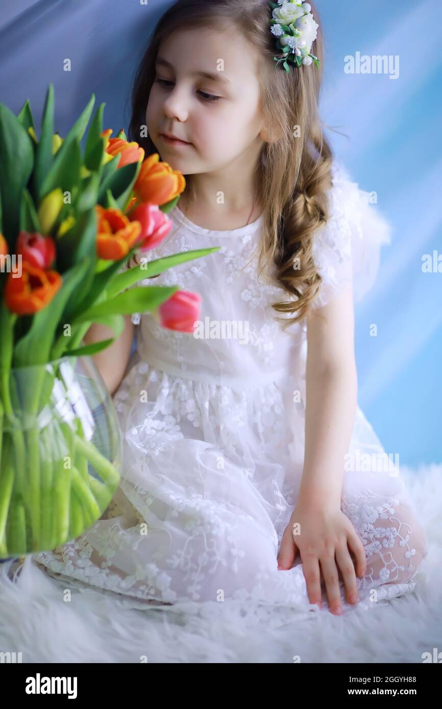 Beautiful girl in white dresses with a magnificent bouquet of first ...