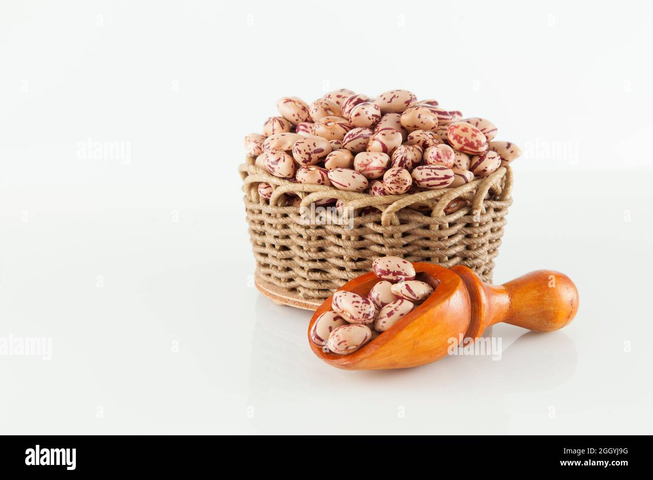 Pinto beans, a legume native to the American continent; photo on white