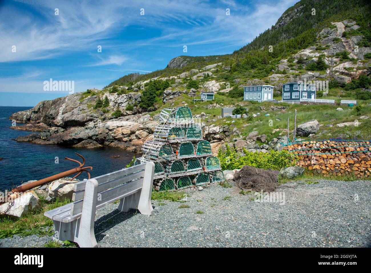 A view of Bauline Harbour, Newfoundland, a small fishing village with a sheltered harbour surrounded by small fishing boats. Stock Photo