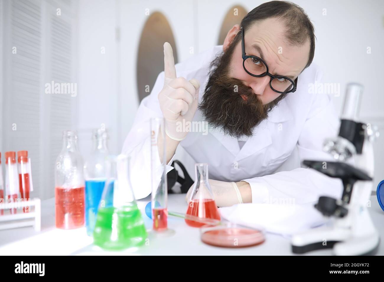 Chemist crazy. A mad scientist conducts experiments in scientific laboratory.  Performs research using a microscope Stock Photo - Alamy, image size:1300x956