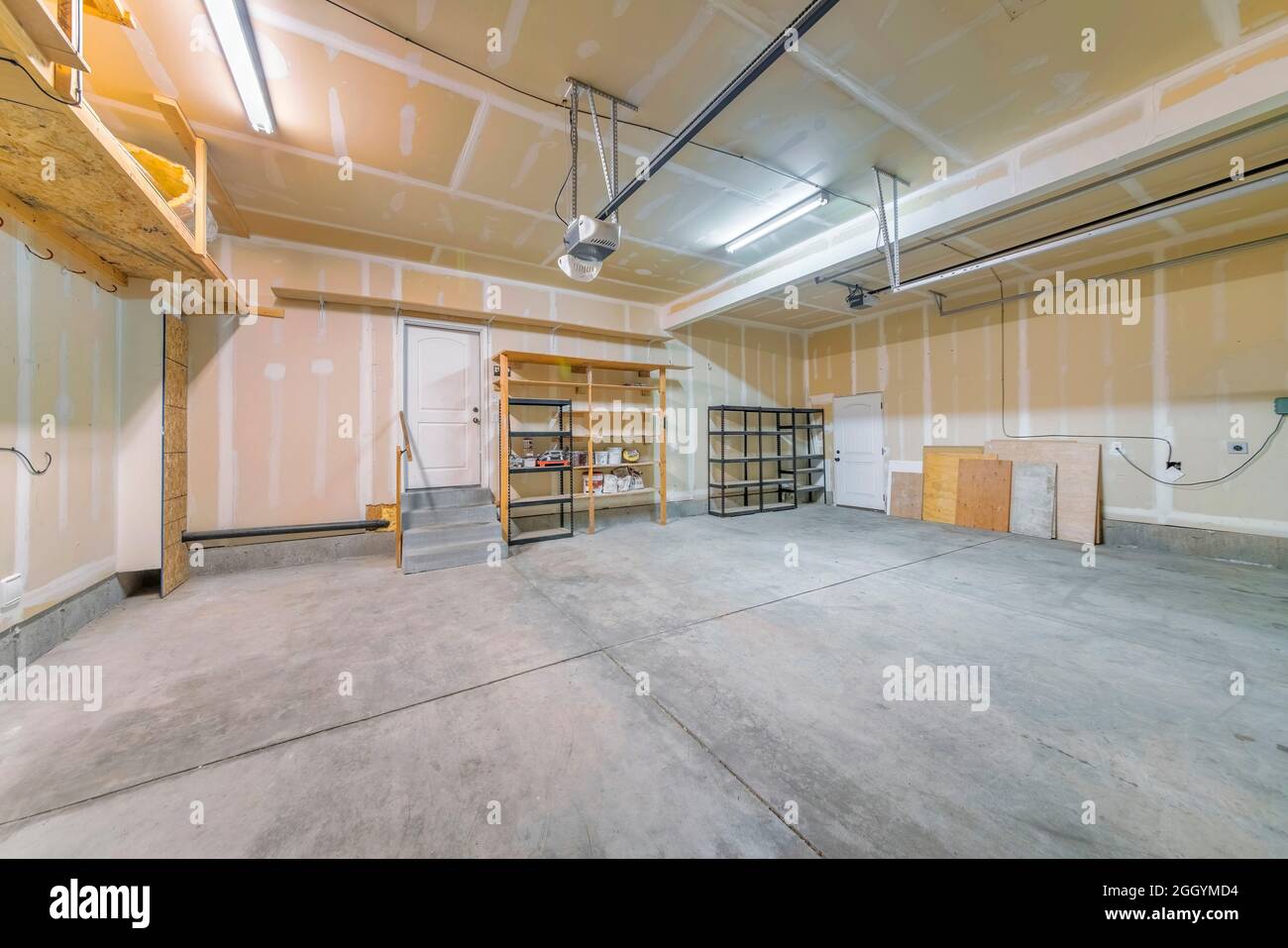 Large unfinished garage interior with wall patch marks Stock Photo Alamy