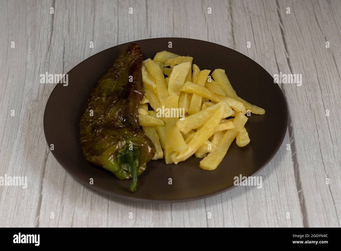 French fries with fried peppers, a very popular food in southern Spain. The potatoes should not
