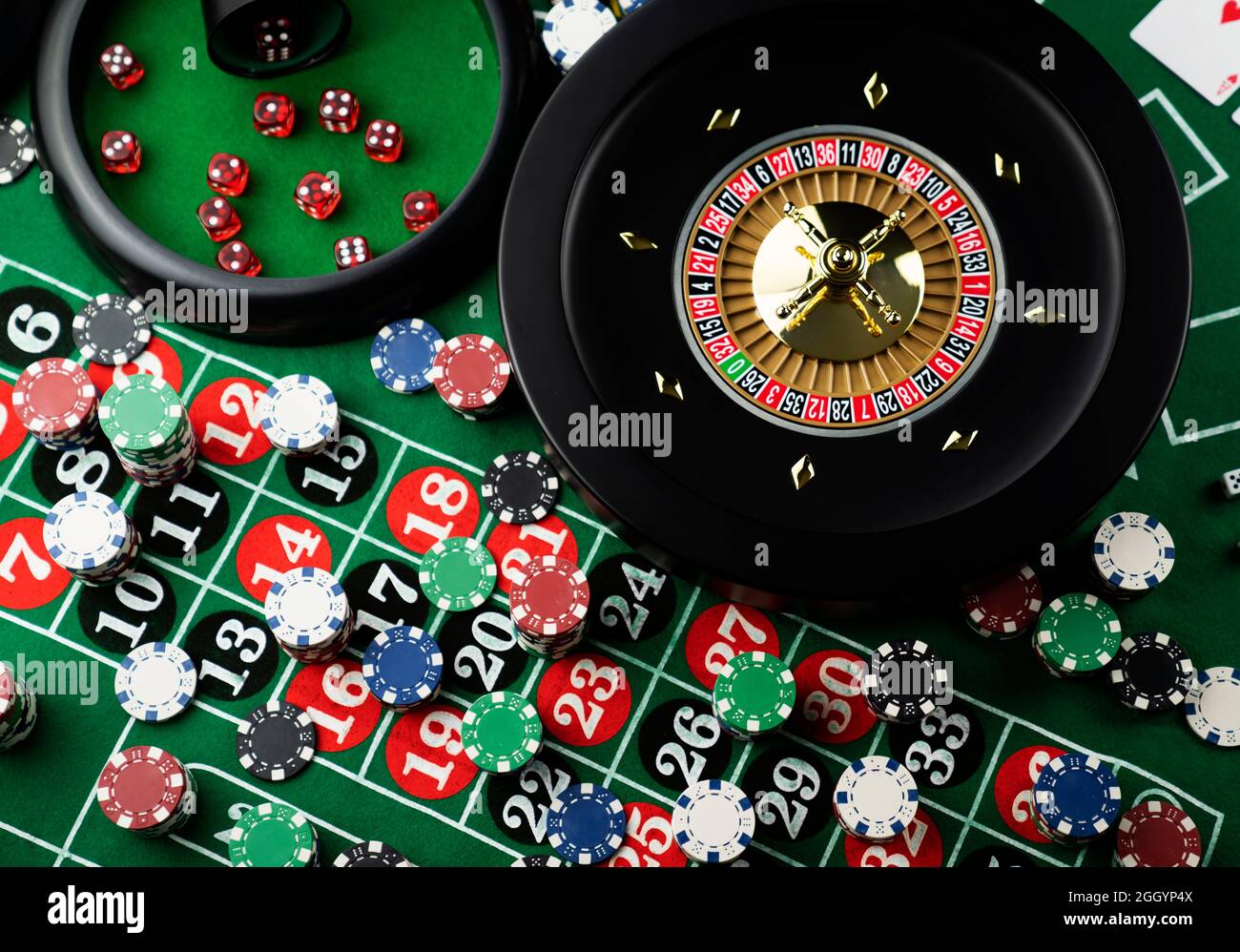 Roulette table in casino. Casino felt green table with red and black  numbers. Stack of poker chips Stock Photo - Alamy