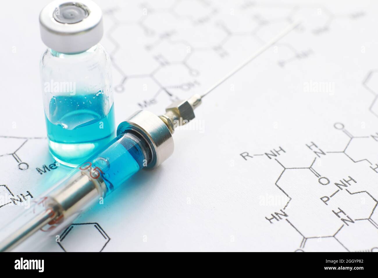 small jars with injection and syringe for injection on blue background ...