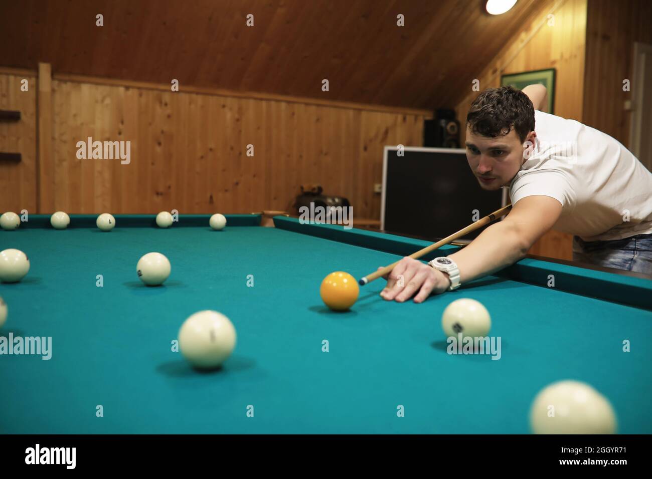 man plays billiards and takes aim before the turn Stock Photo - Alamy