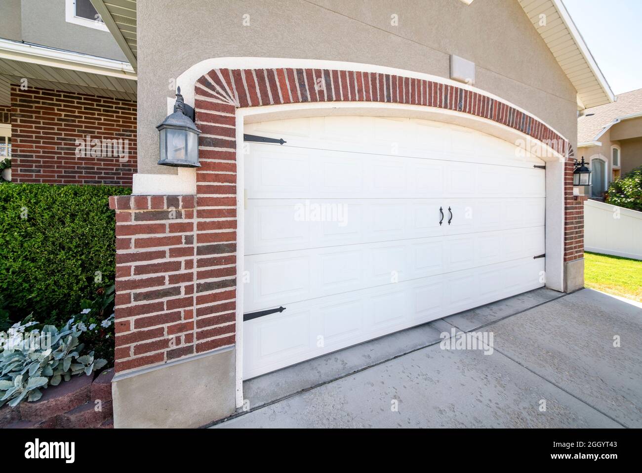 Side hinged white garage door with clipped corner design Stock Photo