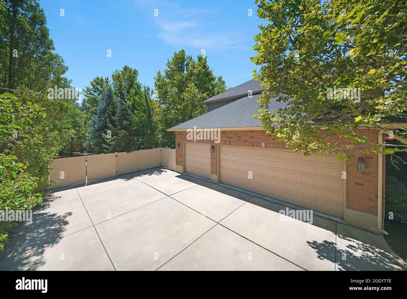 House exterior with threecar garage on the backyard with fence and