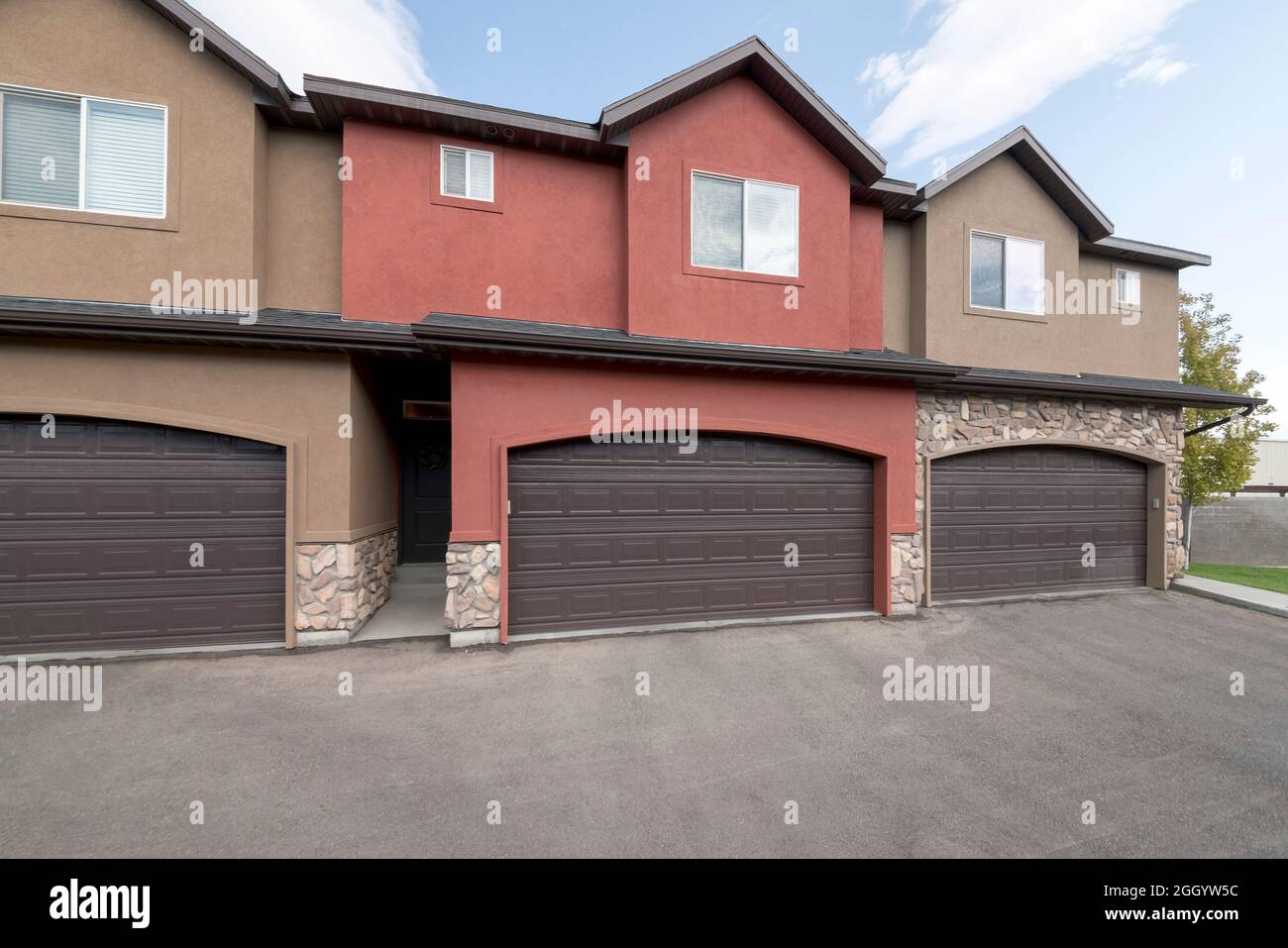 Townhouse exterior with garage and sliding glass windows Stock Photo