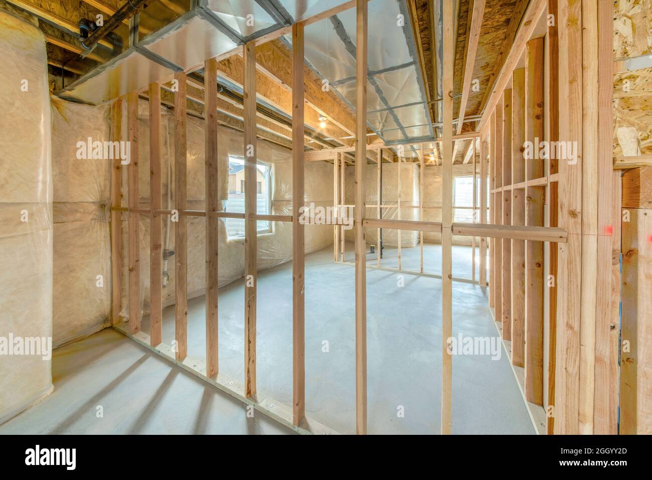 Under construction basement with hardwood frames and plastic vapor