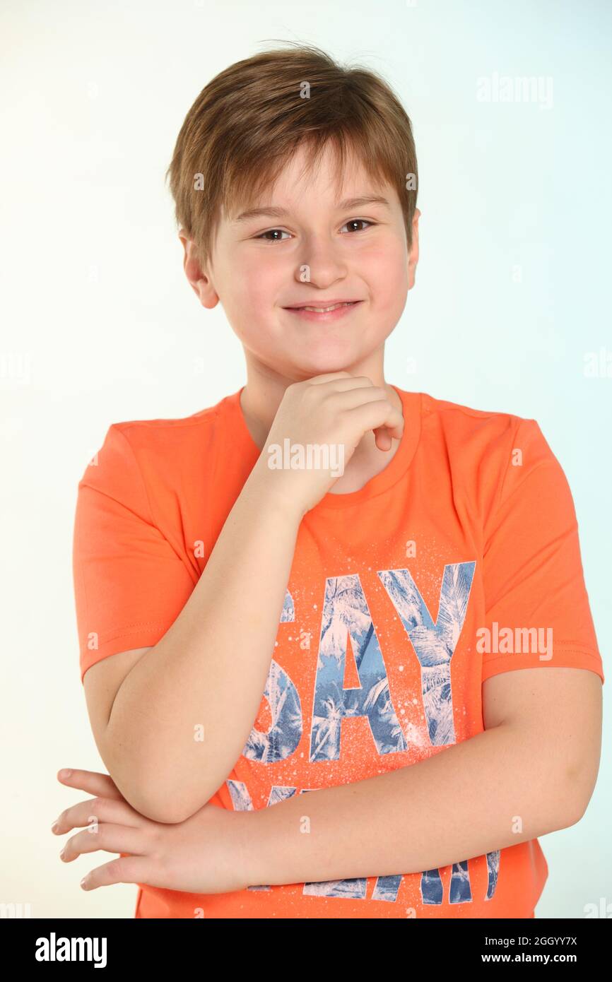 In the portrait, a handsome, developed, cheerful teenage boy in an