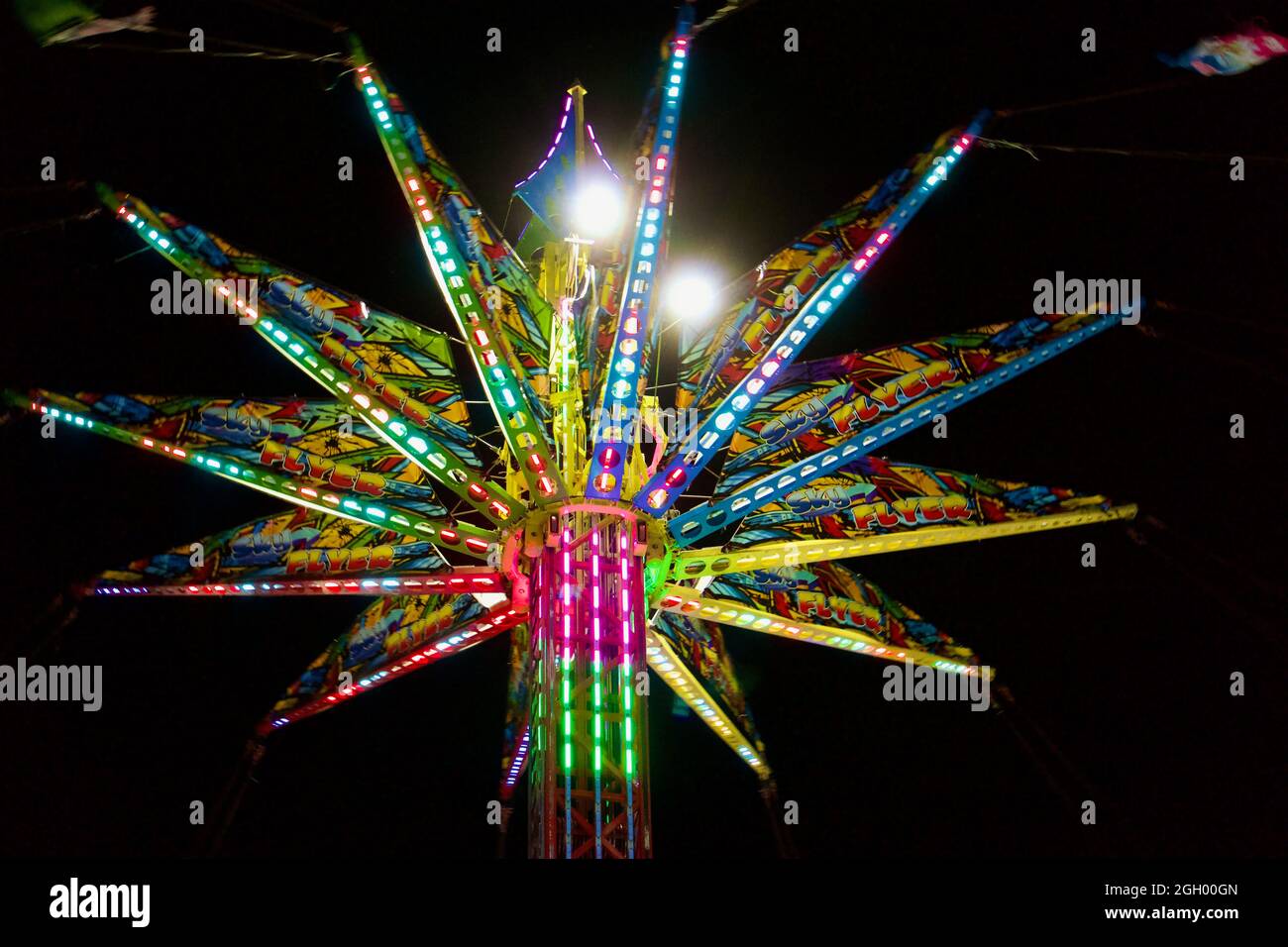 Sky Flyer swing ride on the Midway at night at the 2021 Minnesota State Fair, St. Paul, Minnesota. Stock Photo
