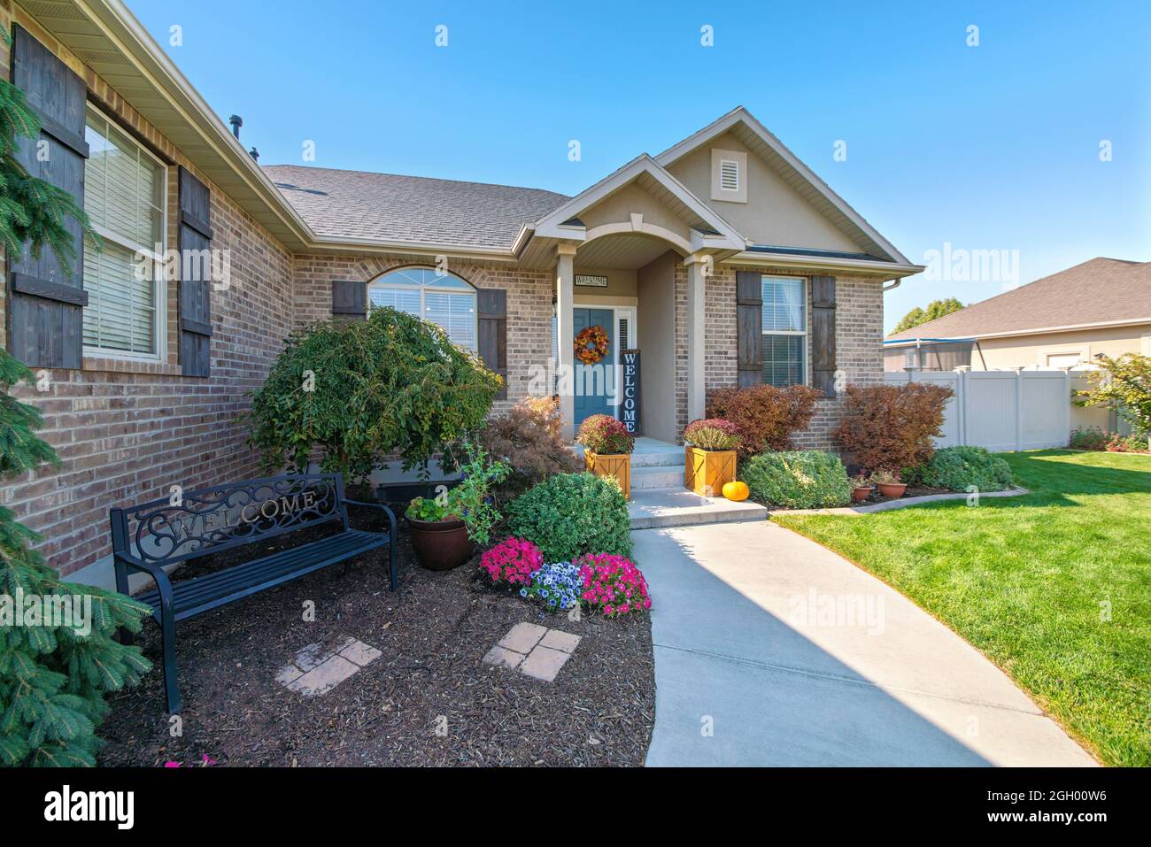 Front exterior of a house with bricks and decorated gary front door Stock Photo