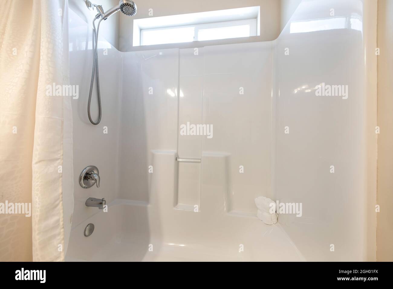 Shower And Bathtub Combo With Wall mounted Shower Head And Faucet Stock shower-and-bathtub-combo-with-wall-mounted-shower-head-and-faucet-stock