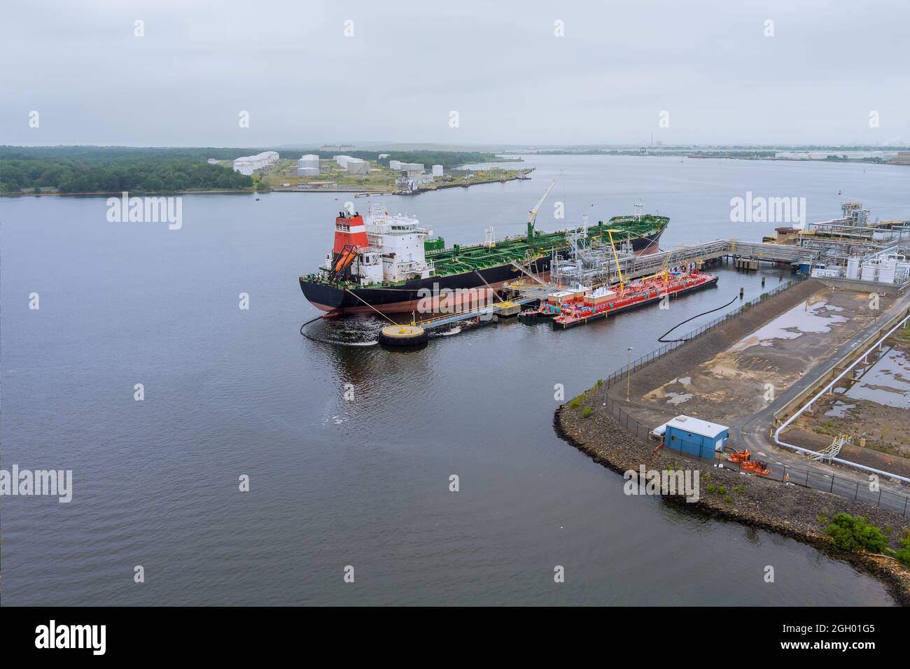 Aerial view of oil tanker ship moored at a oil storage terminal Stock Photo