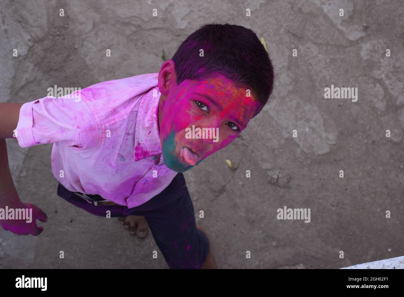 Boy playing with colors, In a happy mood. Concept for Indian festival Holi Stock Photo