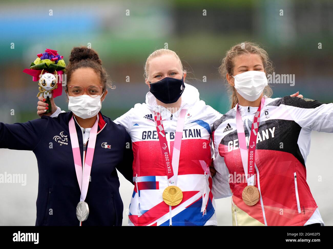 Great Britain's Laura Sugar (centre) celebrates with her gold medal after winning the Women's Kayak Single 200m KL3 Final A alongside France's Nelia Barbosa (left) who took silver and Germany's Felicia Laberer who took the bronze at the Sea Forest Waterway during day eleven of the Tokyo 2020 Paralympic Games in Japan. Picture date: Saturday September 4, 2021. Stock Photo