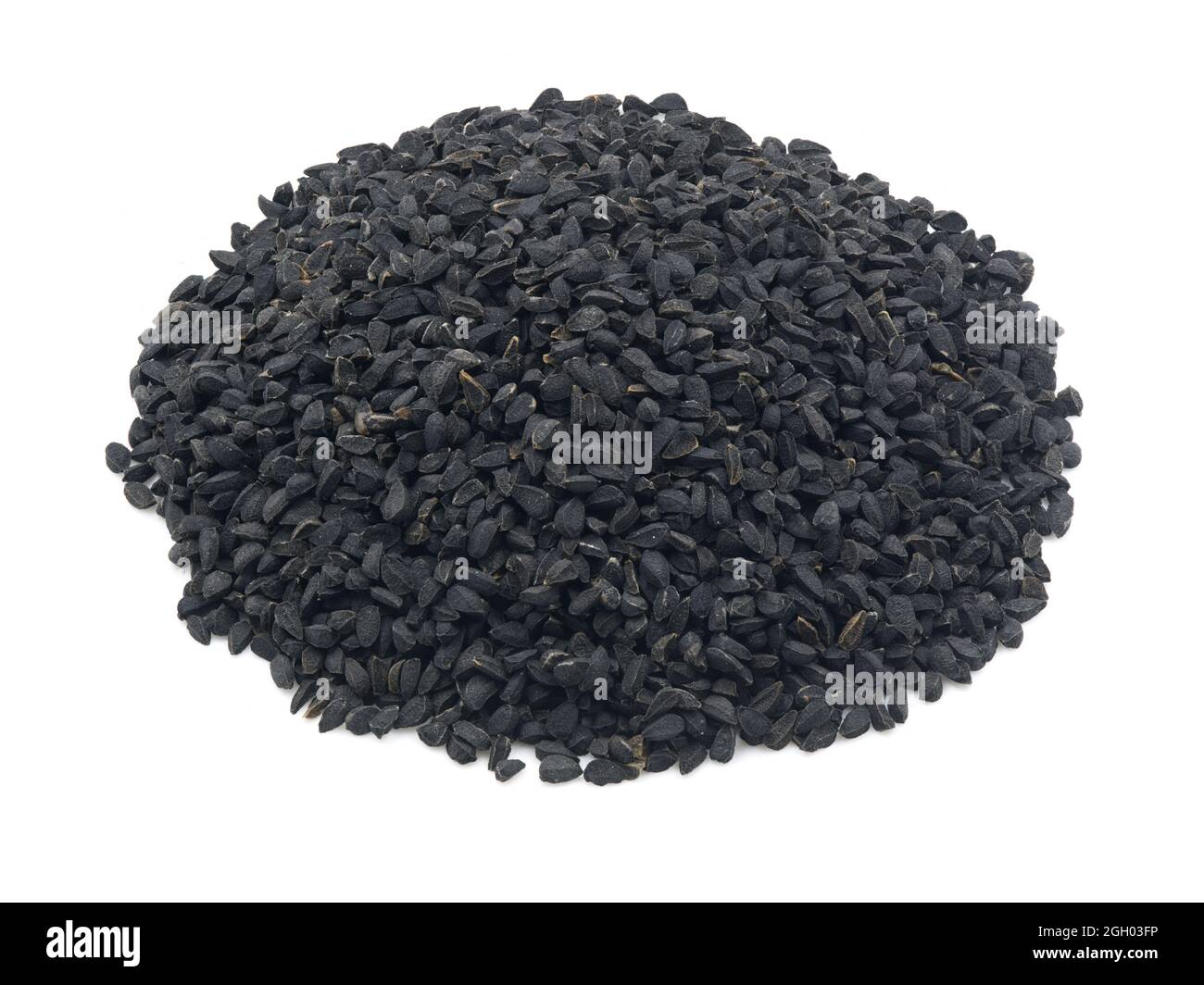 Heap of black cumin or black caraway seeds on a white background. Also called kalonji seeds. Stock Photo