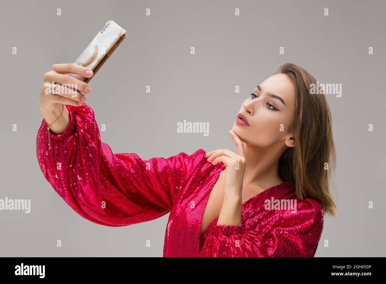 Happy young woman look at shiny mobile phone Stock Photo