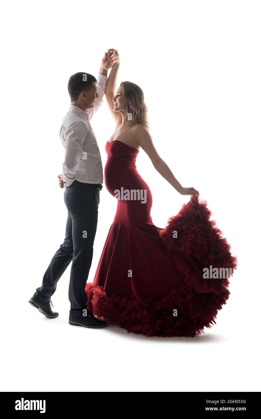 Elegant man with pregnant wife dancing on white background Stock Photo