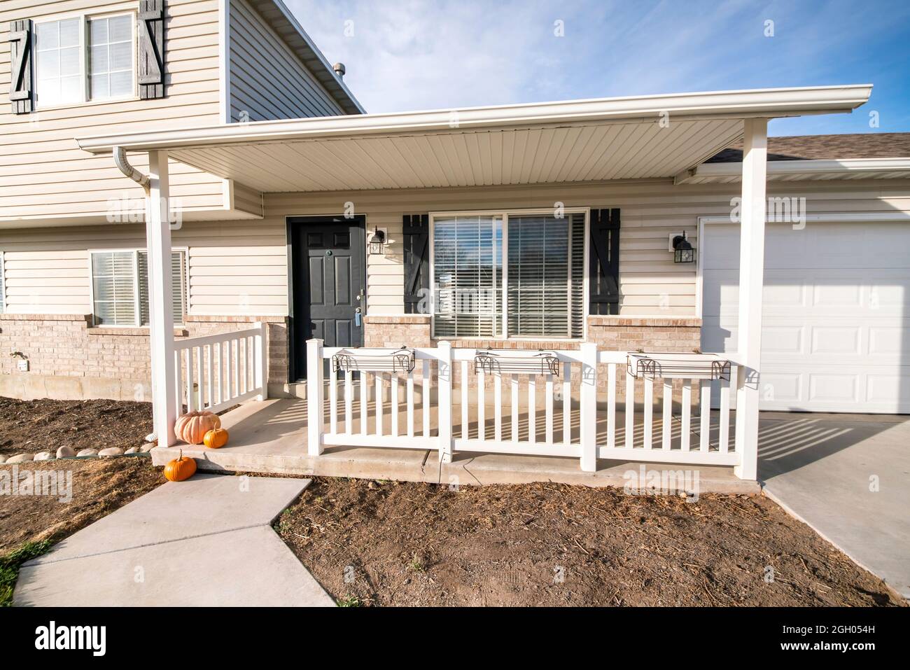 Exterior of a house with white vinyl wood and bricks siding Stock Photo Alamy