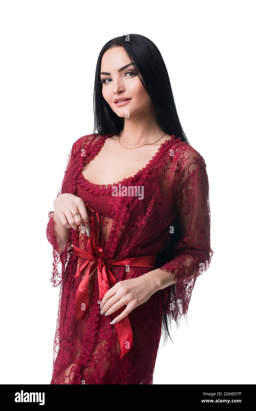 Sexy slimbrunette in red lace peignoir looking playful at camera Stock Photo