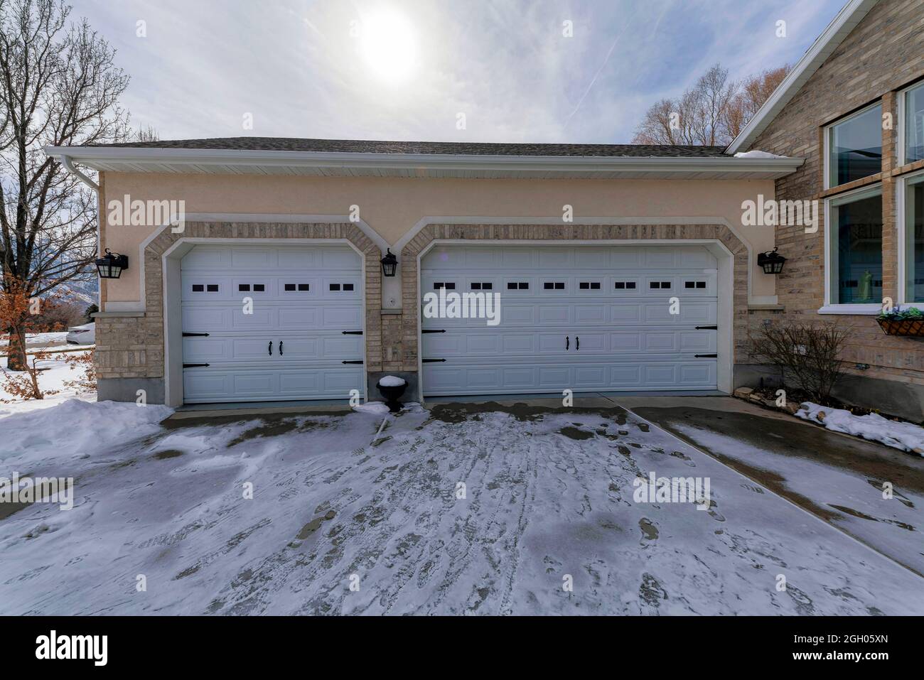 Attached threecar garage exterior of house with bricks Stock Photo Alamy
