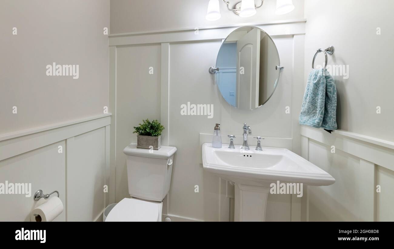 Pano Interior of a powder room with half wooden panel and lights Stock Photo