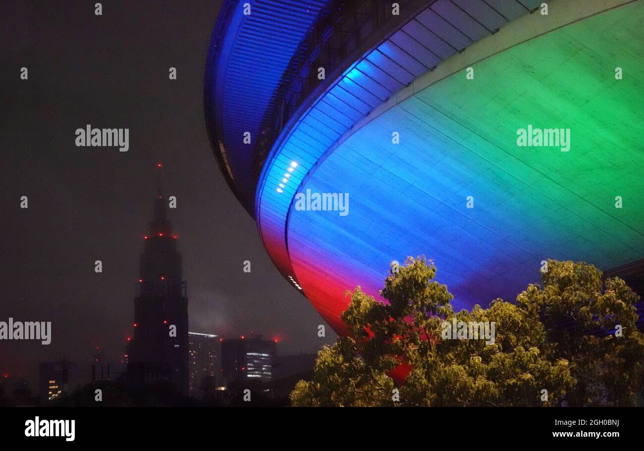 Tokyo, Japan. 03rd Sep, 2021. Paralympics: Athletics, men, 400 m final, at the Olympic Stadium. The Tokyo Metropolitan Gymnasium is colorfully illuminated. Credit: Marcus Brandt/dpa/Alamy Live News Stock Photo