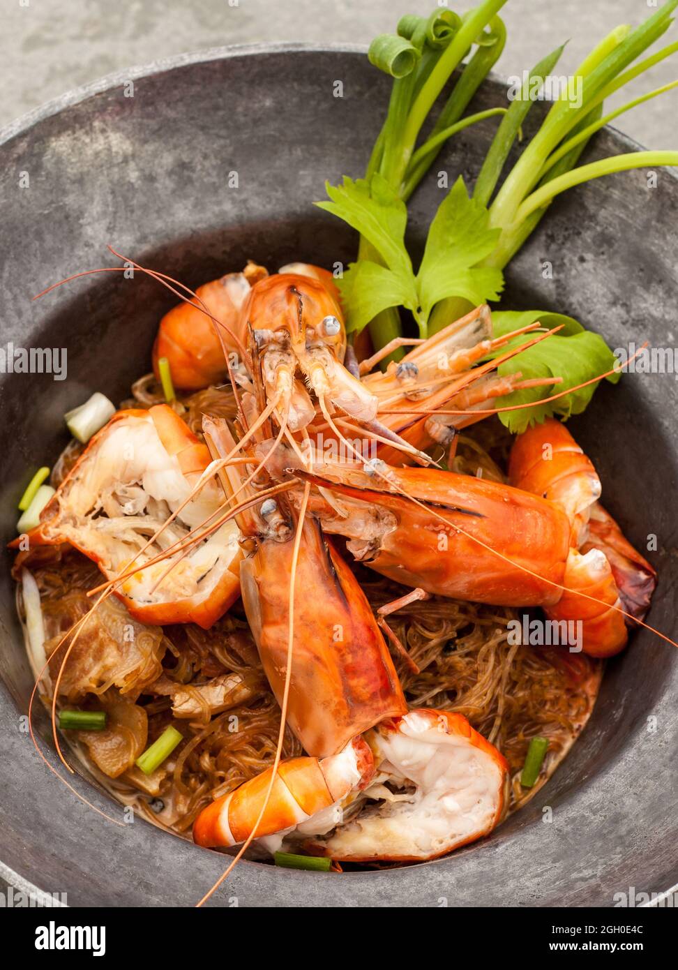 Baked king prawn vermicelli with soya sauce in hot pot Stock Photo Alamy