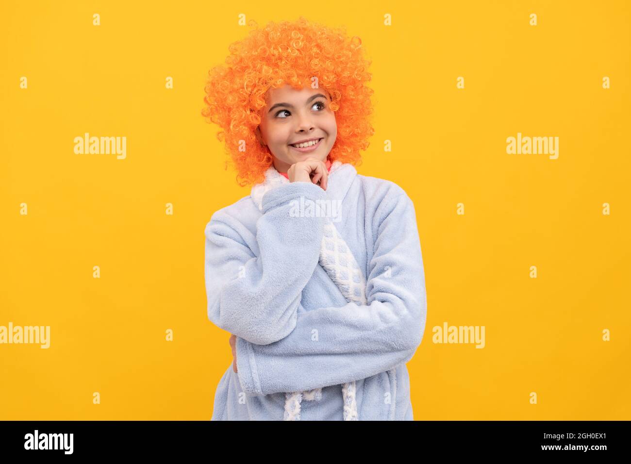 good morning. childhood happiness. birthday or pajama party. funny kid in curly clown wig. Stock Photo