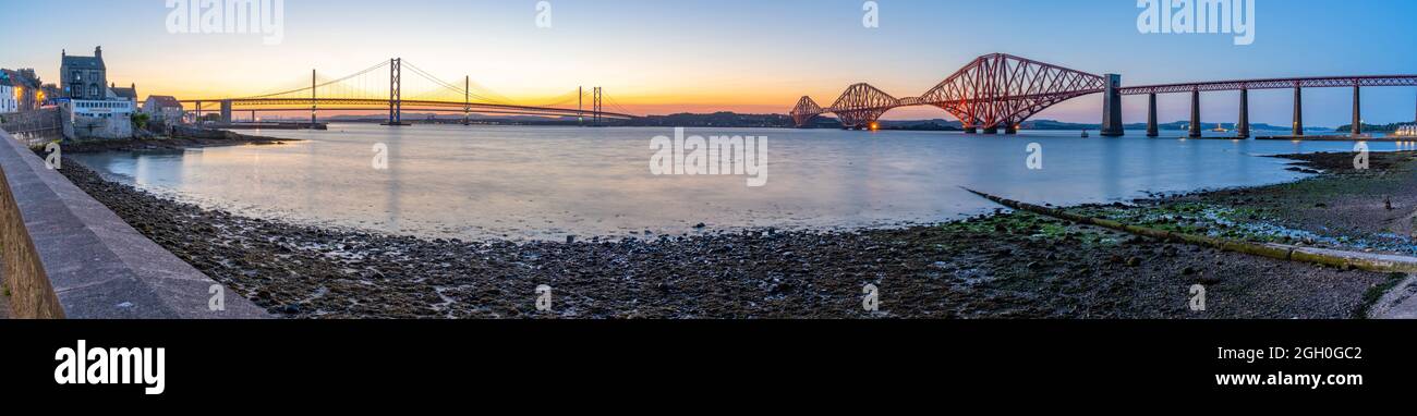 View of the Forth Road Bridge, Queensferry Crossing and Forth Rail Bridge over the Firth of Forth at dusk, South Queensferry, Edinburgh, Lothian, Scot Stock Photo