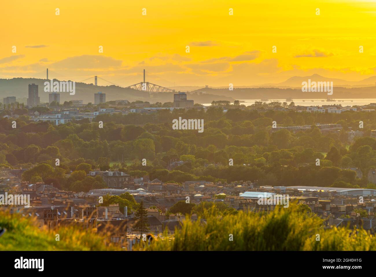 View towards Firth of Forth Bridges from Carlton Hill at golden hour, Edinburgh, Scotland, United Kingdom, Europe Stock Photo