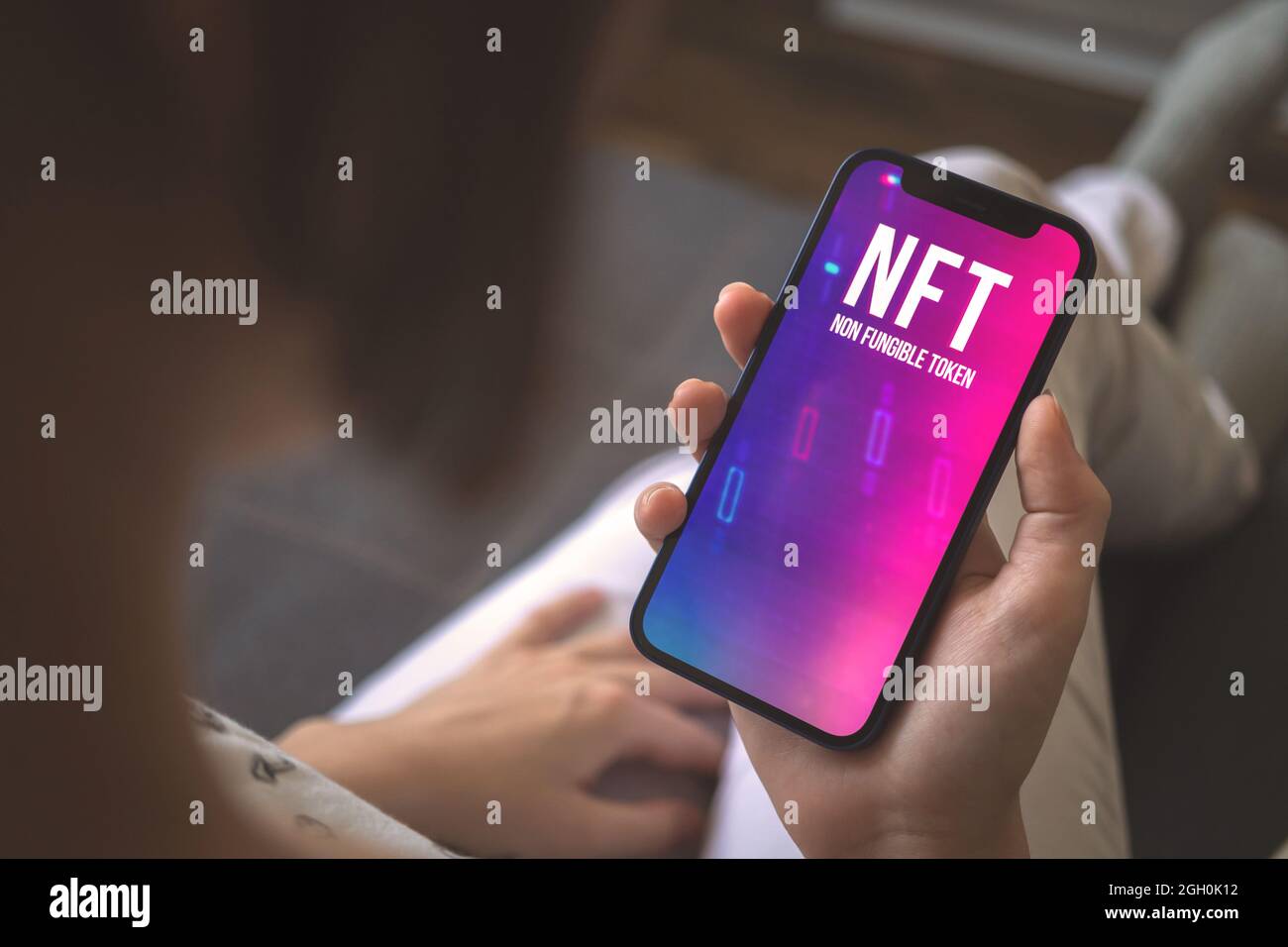 Woman using mobile phone for NFT trading. Concept of non-fungible token, crypto  art and blockchain Stock Photo - Alamy